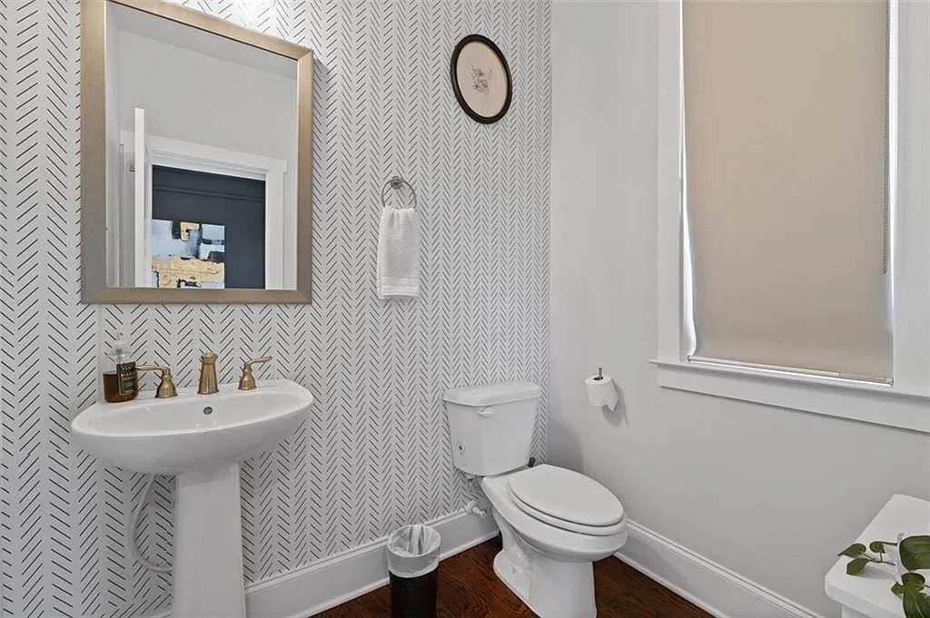 813 Coleman Street Southwest Atlanta, GA 30310 - Photo 16 of 39 a bathroom with a toilet sink and mirror