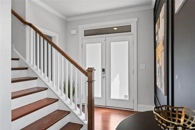 a view of a hallway with wooden floor and windows