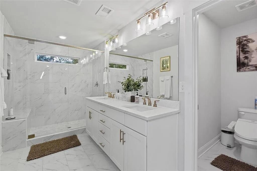 813 Coleman Street Southwest Atlanta, GA 30310 - Photo 25 of 39 a bathroom with a double vanity sink toilet and shower