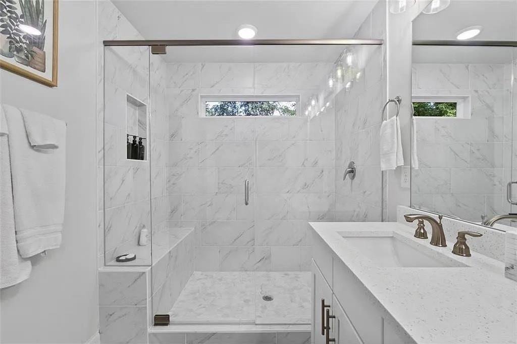 813 Coleman Street Southwest Atlanta, GA 30310 - Photo 26 of 39 a bathroom with a granite countertop sink a shower and a mirror