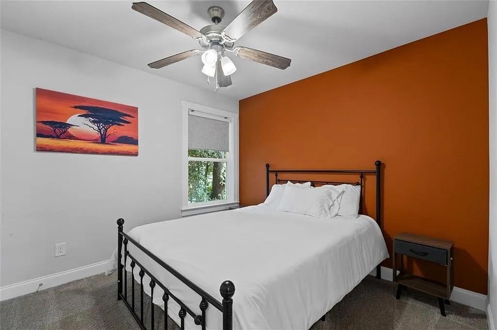 813 Coleman Street Southwest Atlanta, GA 30310 - Photo 30 of 39 a bedroom with a large bed and a chandelier