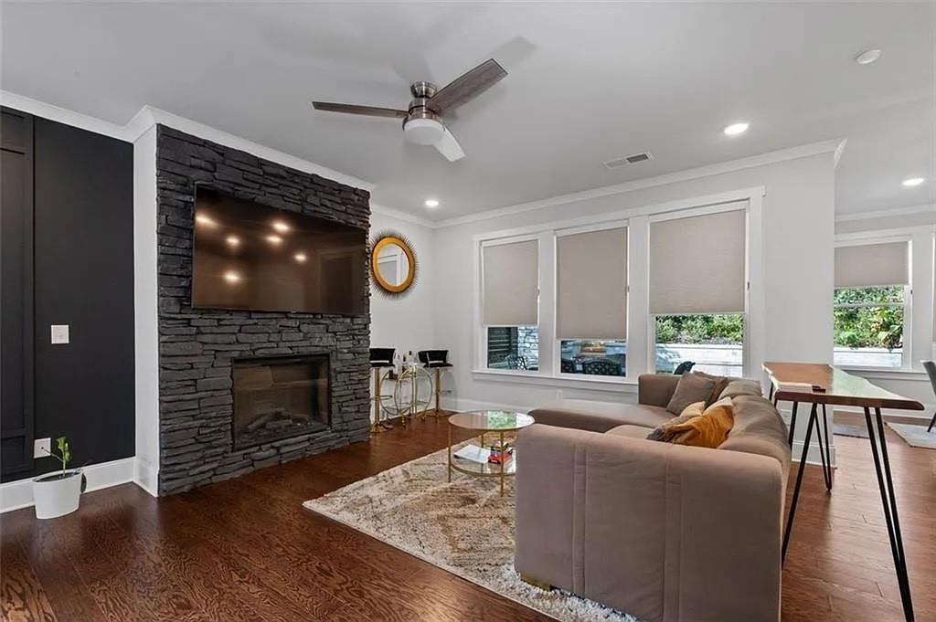 813 Coleman Street Southwest Atlanta, GA 30310 - Photo 3 of 39 a living room with furniture a fireplace and a flat screen tv