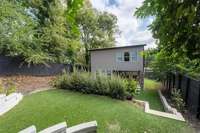 a view of a patio with table and chairs and potted plants