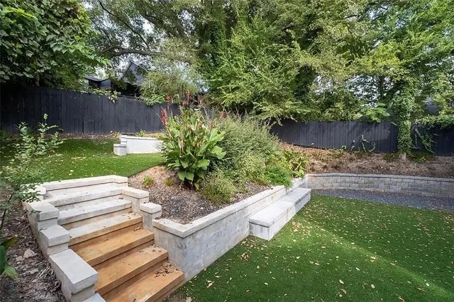 a view of a backyard with plants and a patio