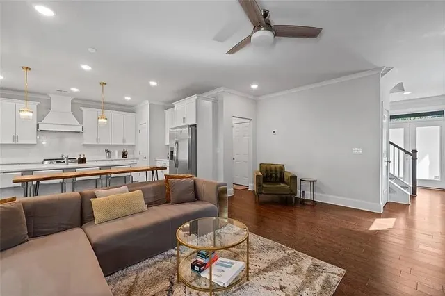 a living room with furniture and wooden floor