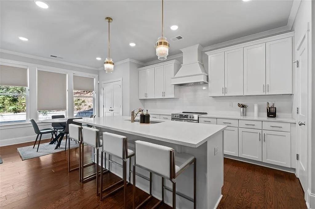 813 Coleman Street Southwest Atlanta, GA 30310 - Photo 6 of 39 a kitchen with a stove a window and chairs