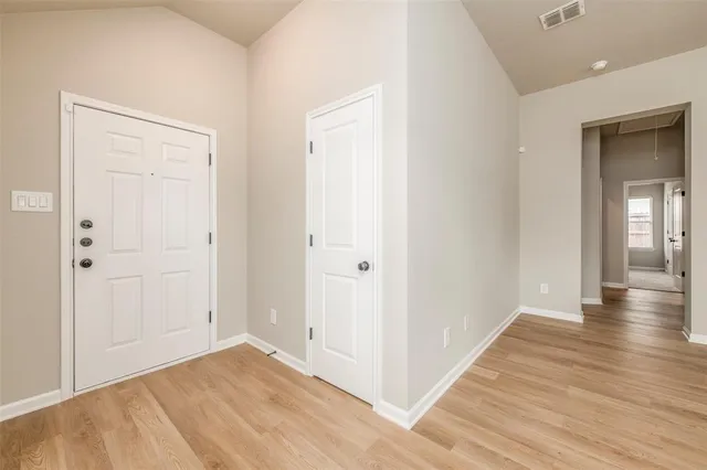 a view of a hallway with wooden floor