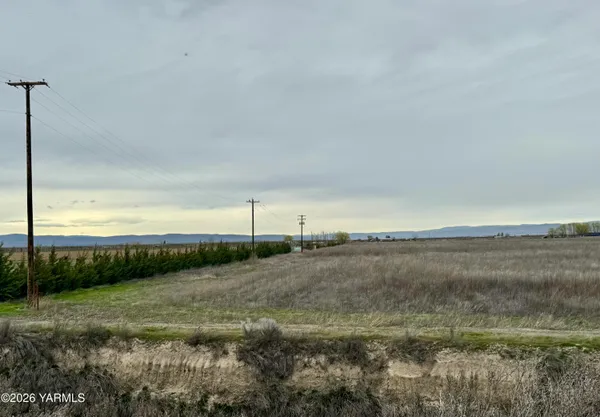a view of a field with wooden fence