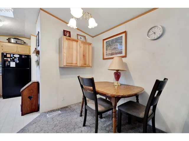 a view of a dining room with furniture and a chandelier