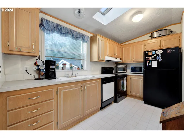 a kitchen with a refrigerator and window
