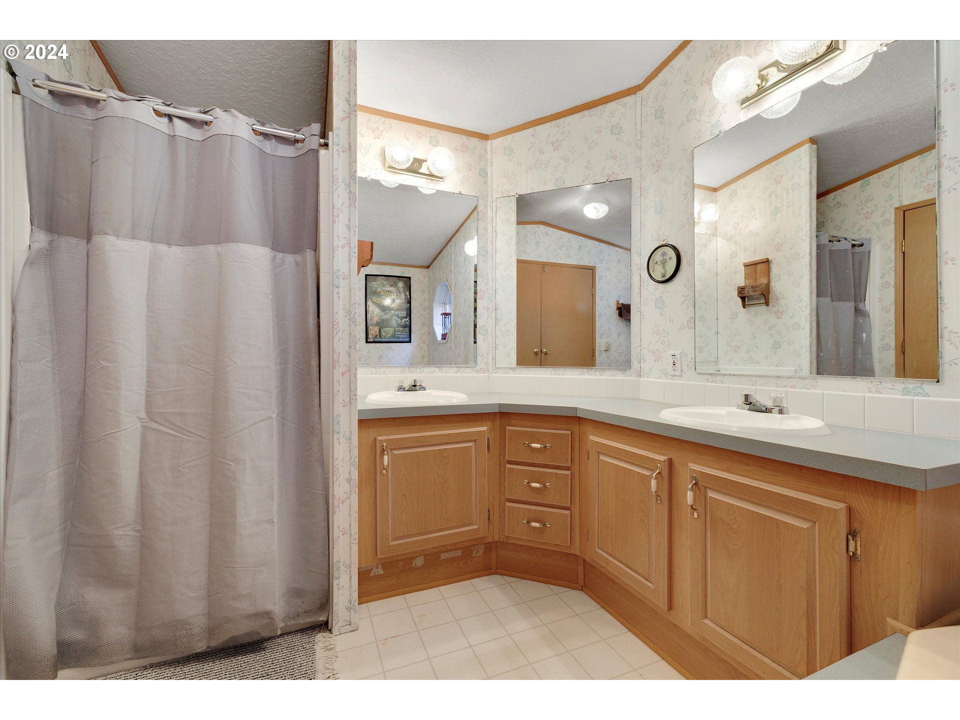 8750 Southeast 155th Avenue, Unit 53 Happy Valley, OR 97086 - Photo 24 of 29 a spacious bathroom with a double vanity sink a mirror and a shower
