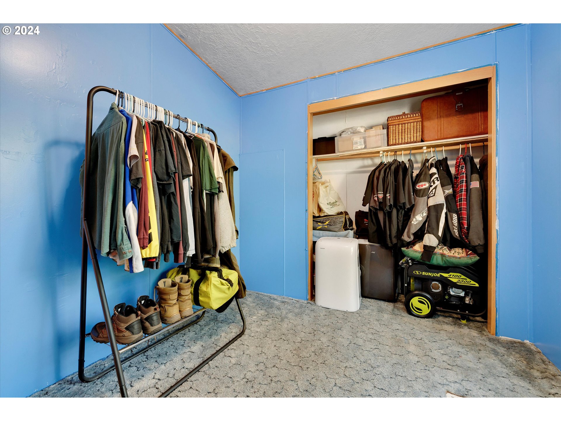 8750 Southeast 155th Avenue, Unit 53 Happy Valley, OR 97086 - Photo 27 of 29 a view of walk in closet with clothes and shoes