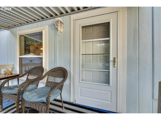 a room that has a dresser and a chair with wooden floor