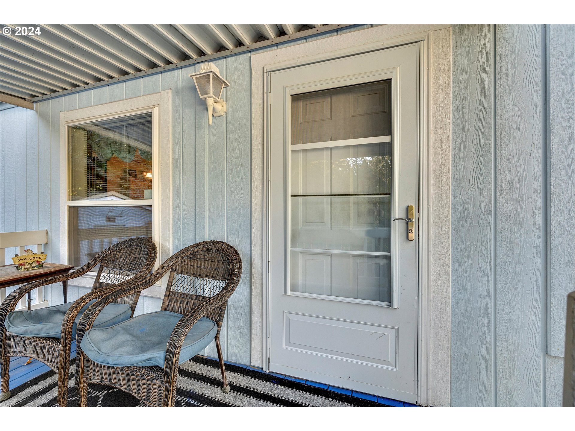 8750 Southeast 155th Avenue, Unit 53 Happy Valley, OR 97086 - Photo 8 of 29 a room that has a dresser and a chair with wooden floor
