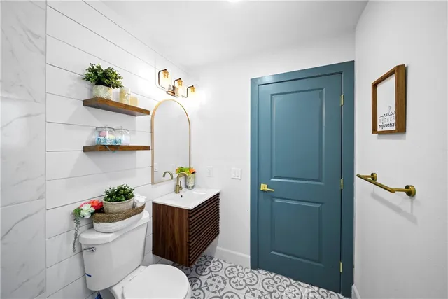 a bathroom with a sink mirror and toilet