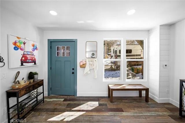 a bedroom with furniture and wooden floor