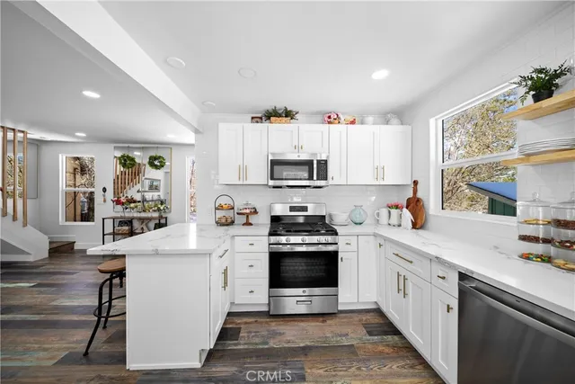 a kitchen with white cabinets and white appliances