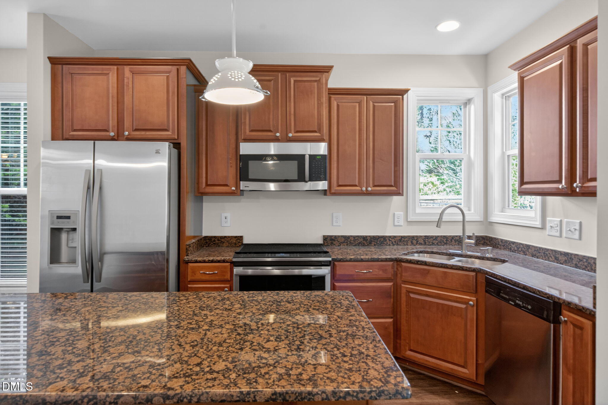 3834 Cumberland Pond Road Raleigh, NC 27606 - Photo 10 of 31 a kitchen with stainless steel appliances granite countertop a sink refrigerator stove microwave and cabinets
