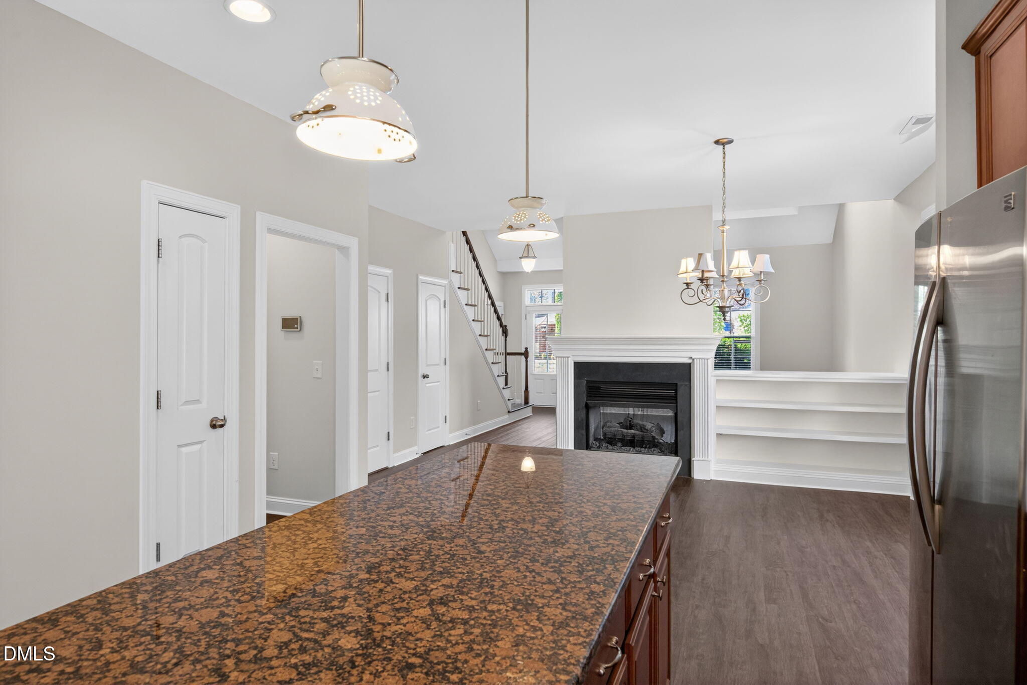 3834 Cumberland Pond Road Raleigh, NC 27606 - Photo 11 of 31 a view of a livingroom with a fireplace a chandelier and entryway