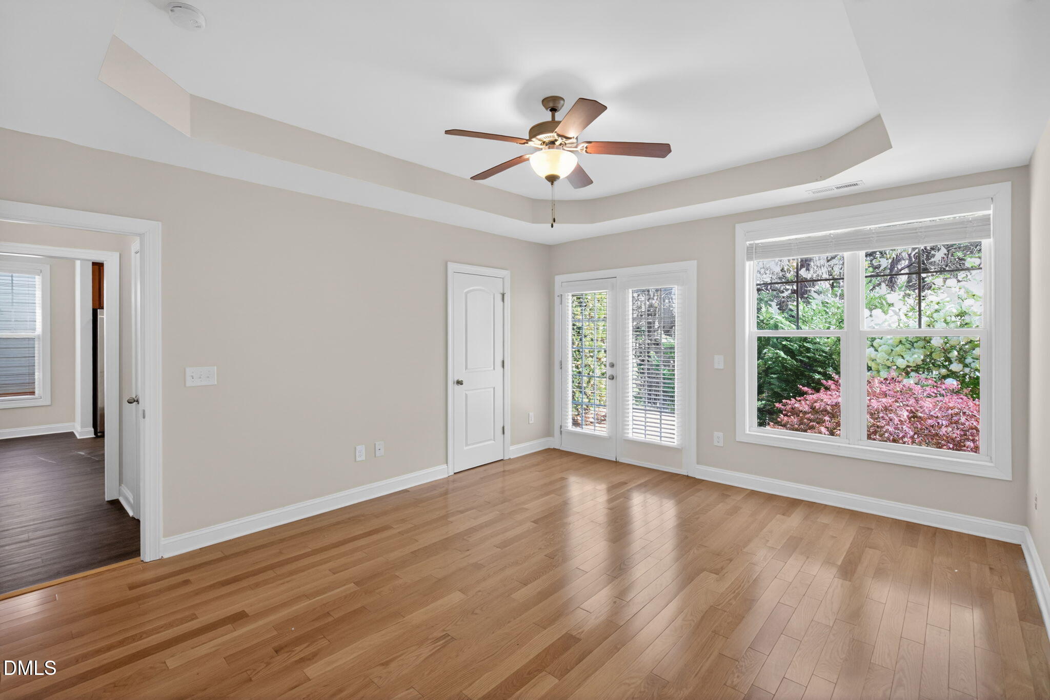 3834 Cumberland Pond Road Raleigh, NC 27606 - Photo 13 of 31 a view of an empty room with wooden floor and a window