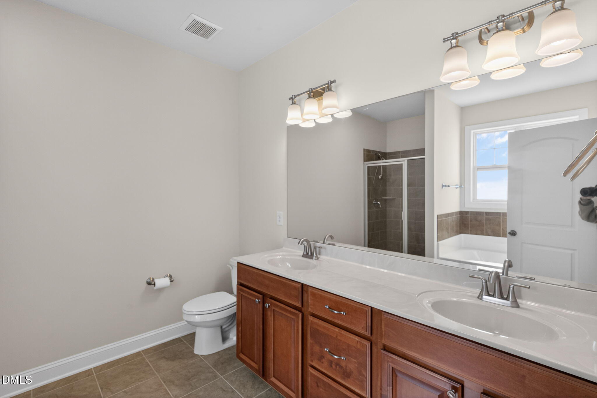 3834 Cumberland Pond Road Raleigh, NC 27606 - Photo 15 of 31 a bathroom with a double vanity sink and a toilet