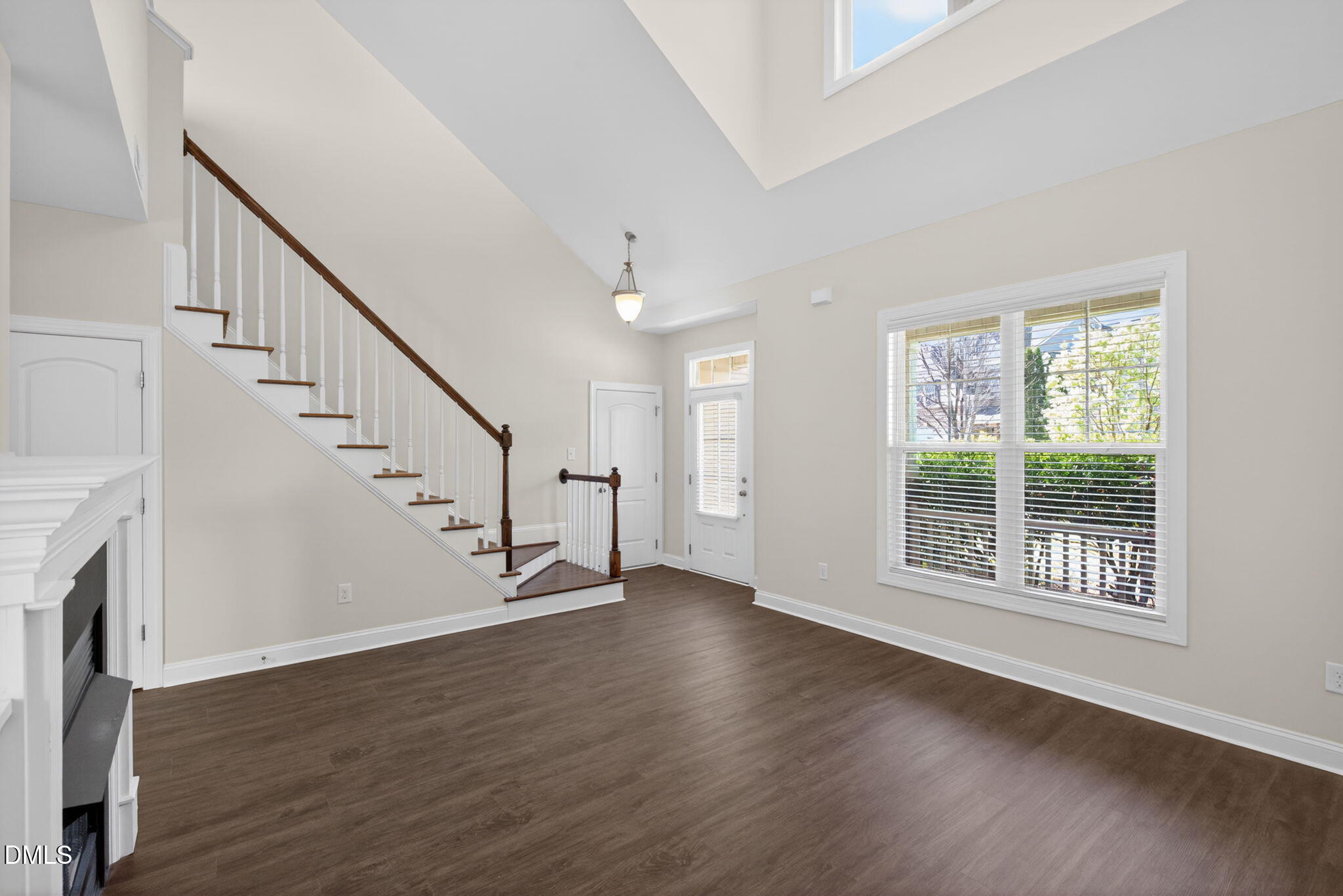 3834 Cumberland Pond Road Raleigh, NC 27606 - Photo 3 of 31 a view of an empty room with wooden floor and a window
