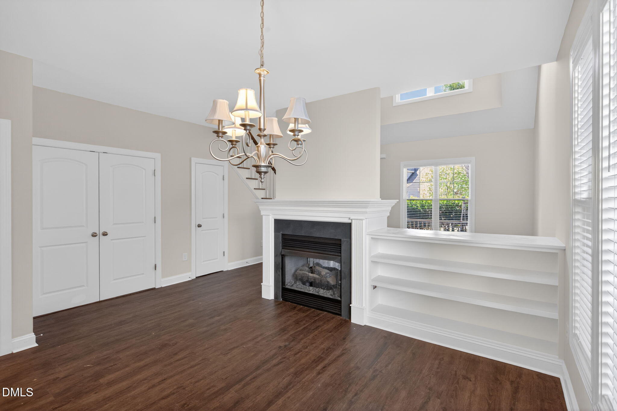 3834 Cumberland Pond Road Raleigh, NC 27606 - Photo 6 of 31 a view of an empty room with wooden floor fireplace and a window
