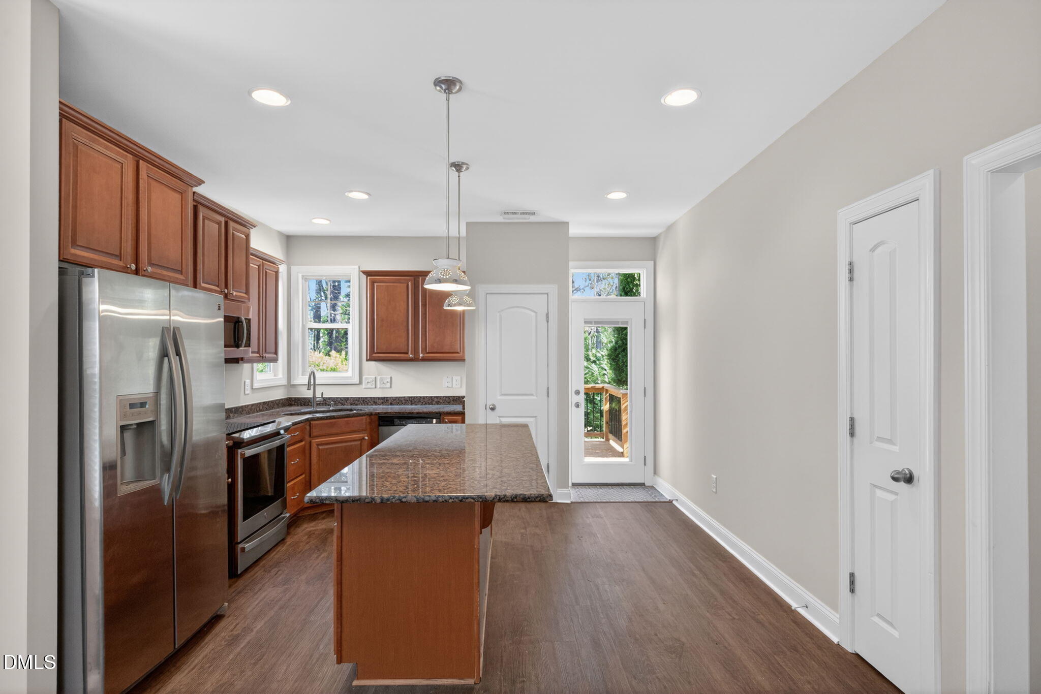 3834 Cumberland Pond Road Raleigh, NC 27606 - Photo 8 of 31 a kitchen with a refrigerator a sink and wooden floor