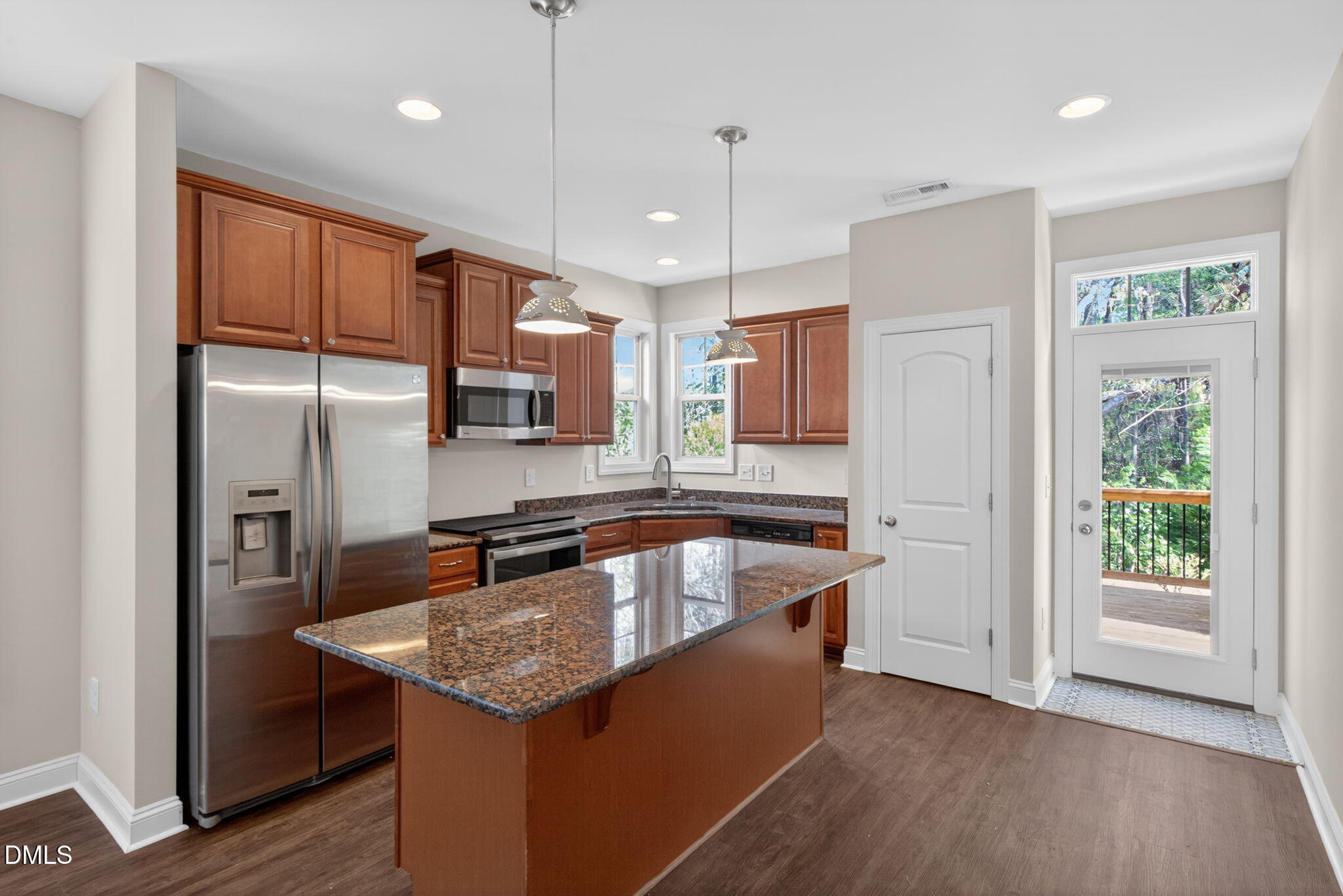 3834 Cumberland Pond Road Raleigh, NC 27606 - Photo 9 of 31 a kitchen with stainless steel appliances granite countertop a sink a refrigerator and a center island