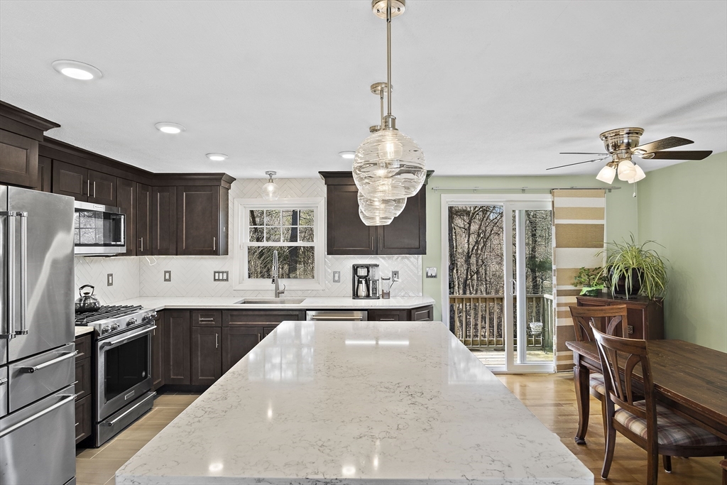 29 Dix Rd Extension Woburn, MA 01801 - Photo 11 of 40 a kitchen with stainless steel appliances a sink stove and refrigerator