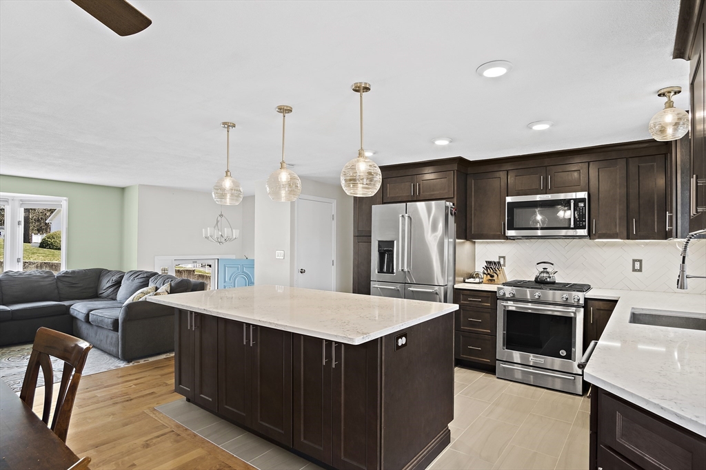 29 Dix Rd Extension Woburn, MA 01801 - Photo 14 of 40 a kitchen with kitchen island a sink appliances and cabinets
