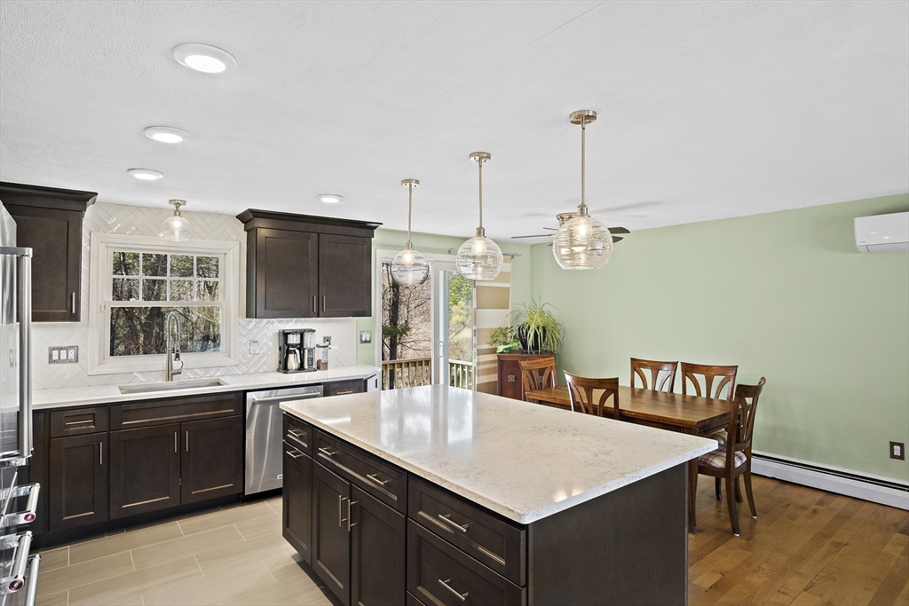 29 Dix Rd Extension Woburn, MA 01801 - Photo 18 of 40 a kitchen that has a sink and a table in it