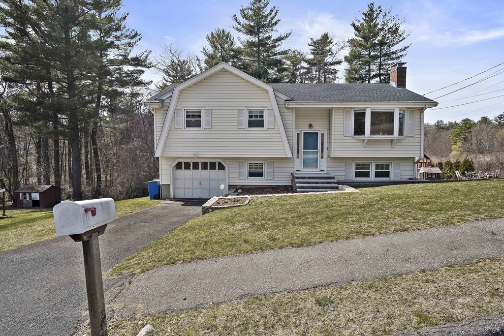 29 Dix Rd Extension Woburn, MA 01801 - Photo 2 of 40 a front view of a house with a yard and garage