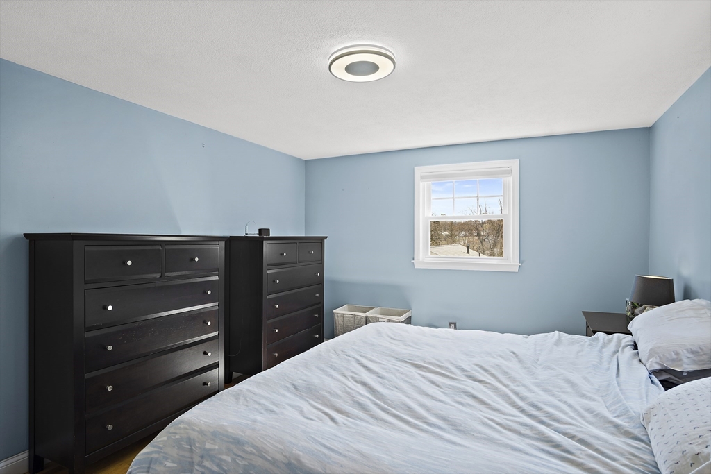 29 Dix Rd Extension Woburn, MA 01801 - Photo 23 of 40 a bedroom with a bed and a dresser