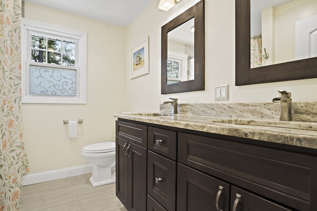 29 Dix Rd Extension Woburn, MA 01801 - Photo 24 of 40 a bathroom with a granite countertop sink toilet and mirror