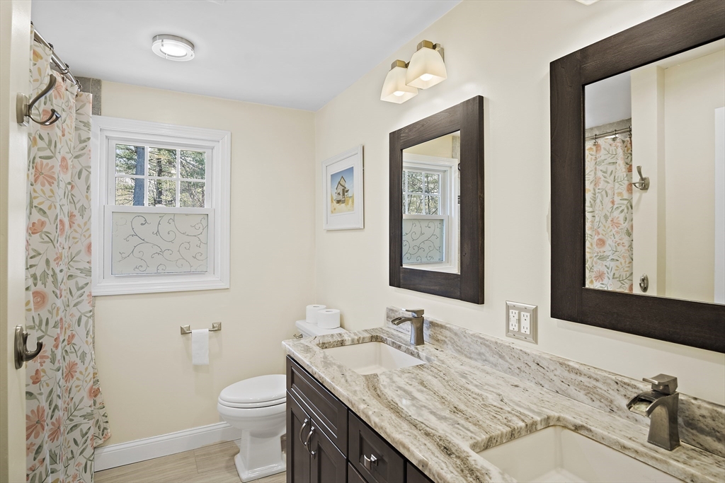 29 Dix Rd Extension Woburn, MA 01801 - Photo 25 of 40 a bathroom with a granite countertop sink and a mirror