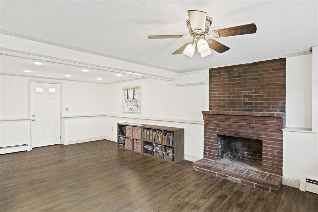 29 Dix Rd Extension Woburn, MA 01801 - Photo 31 of 40 a view of an empty room with a fireplace and a window