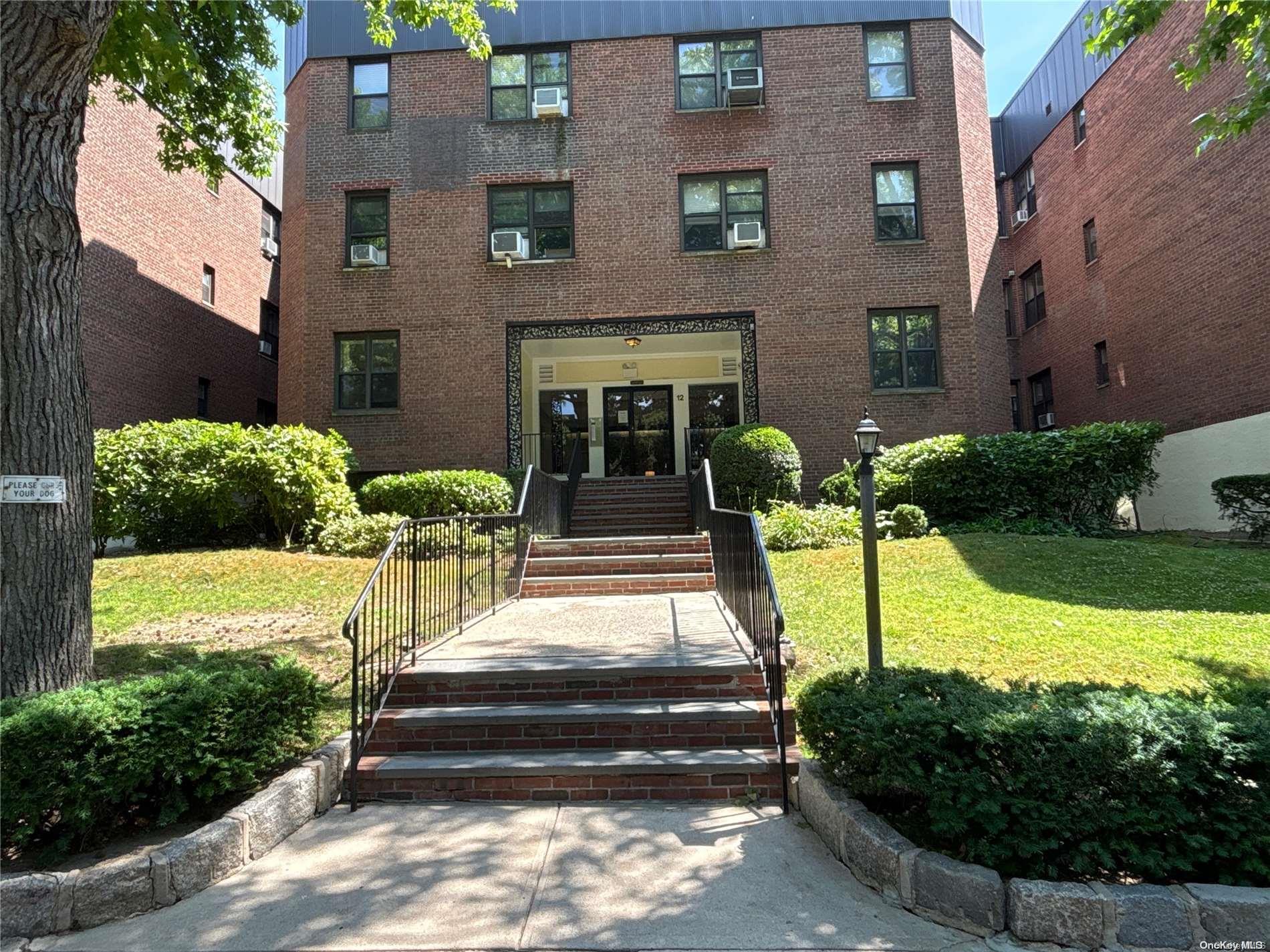 12 Welwyn Road, Unit 3K Great Neck, NY 11021 - Photo 1 of 1 a front view of a house with garden