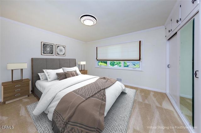 a white house with a large pool and lawn chairs