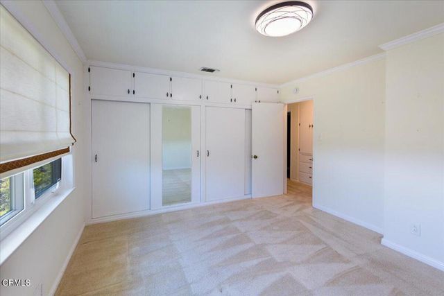 a view of a house with backyard sitting area and garden