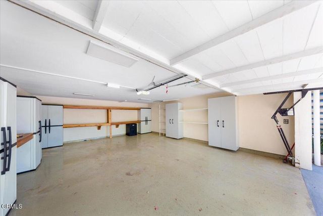an aerial view of a house with a swimming pool and outdoor space