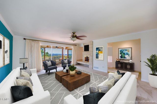 a living room with furniture and a fireplace