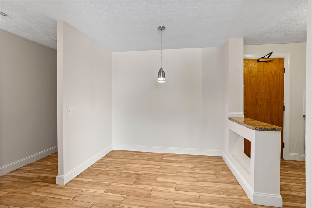 17 Davis Road, Unit C9 Acton, MA 01720 - Photo 16 of 26 a view of a room with wooden floor and brick wall