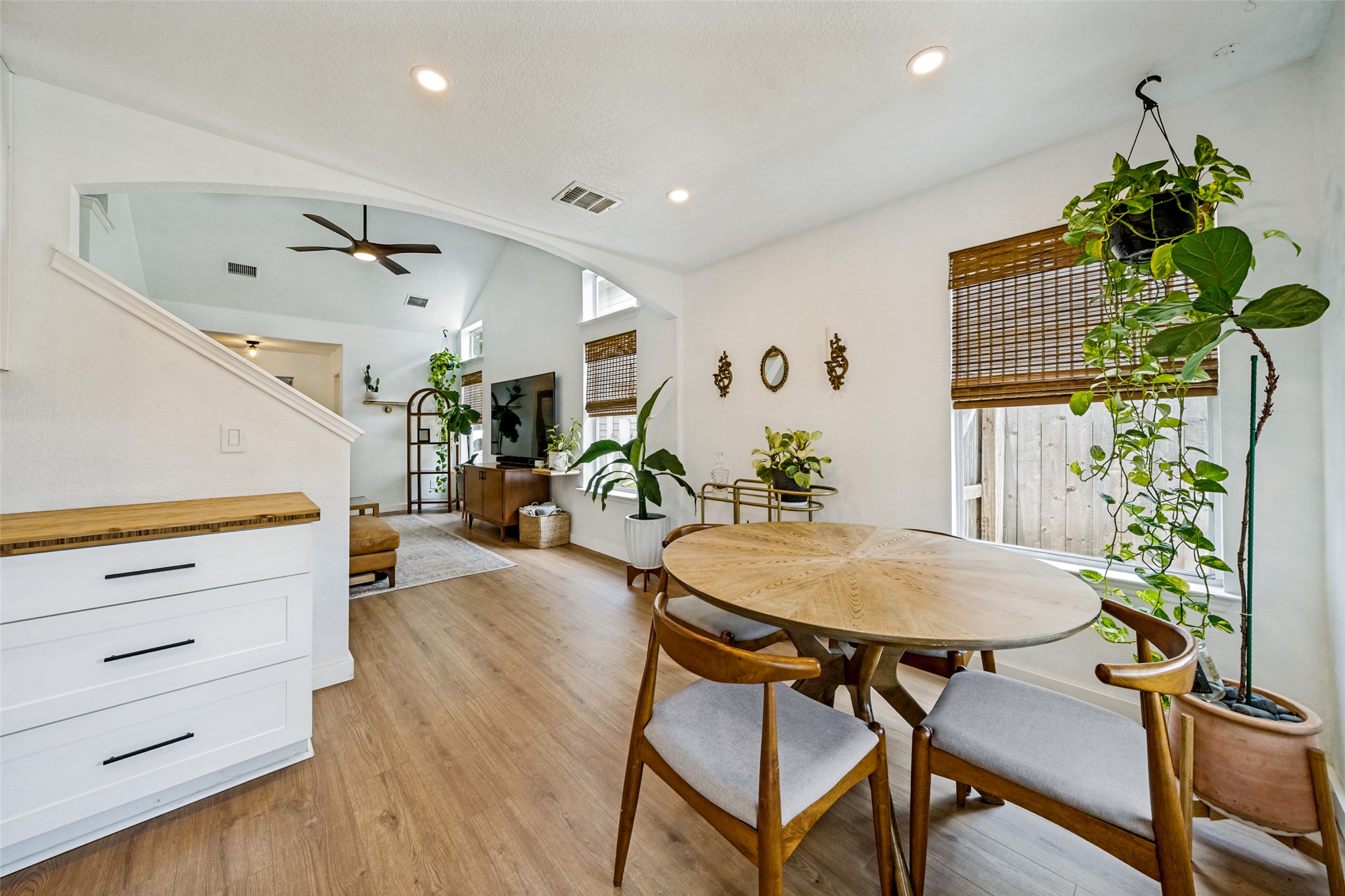 9205 Rowlands Sayle Road Austin, TX 78744 - Photo 10 of 25 An open concept living and dining area boasts vaulted ceilings and bright windows, creating an inviting space.