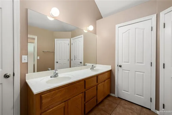 a bathroom with a sink double vanity and a mirror