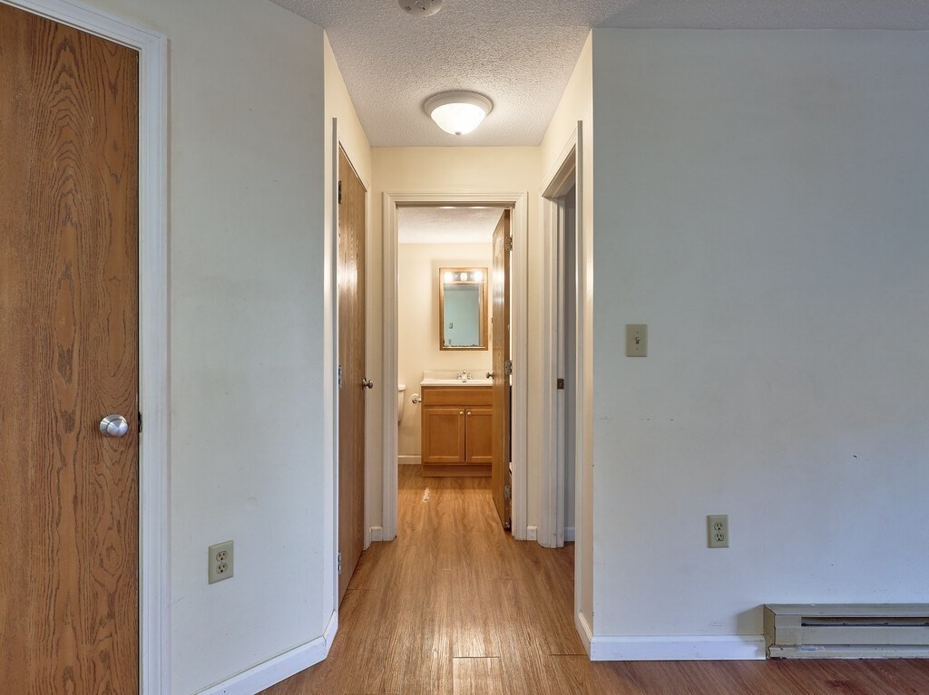 80 Stanton Street, Unit 14 Worcester, MA 01605 - Photo 15 of 26 a view of a hallway with wooden floor