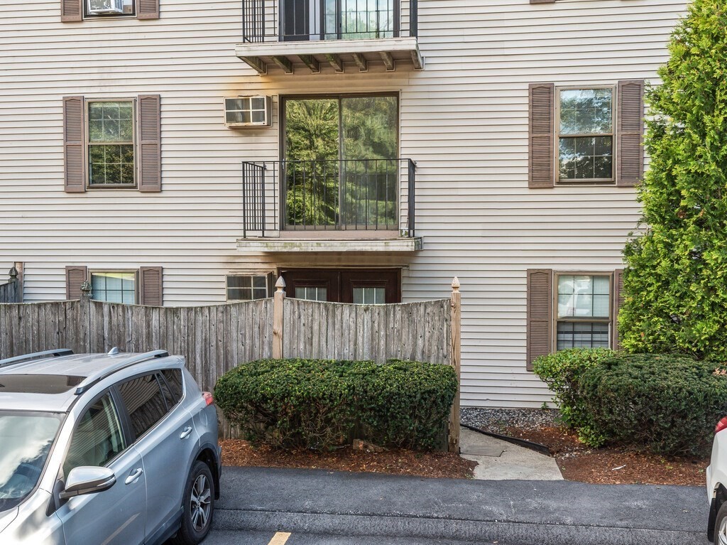 80 Stanton Street, Unit 14 Worcester, MA 01605 - Photo 22 of 26 a view of a house with a small window and potted plants