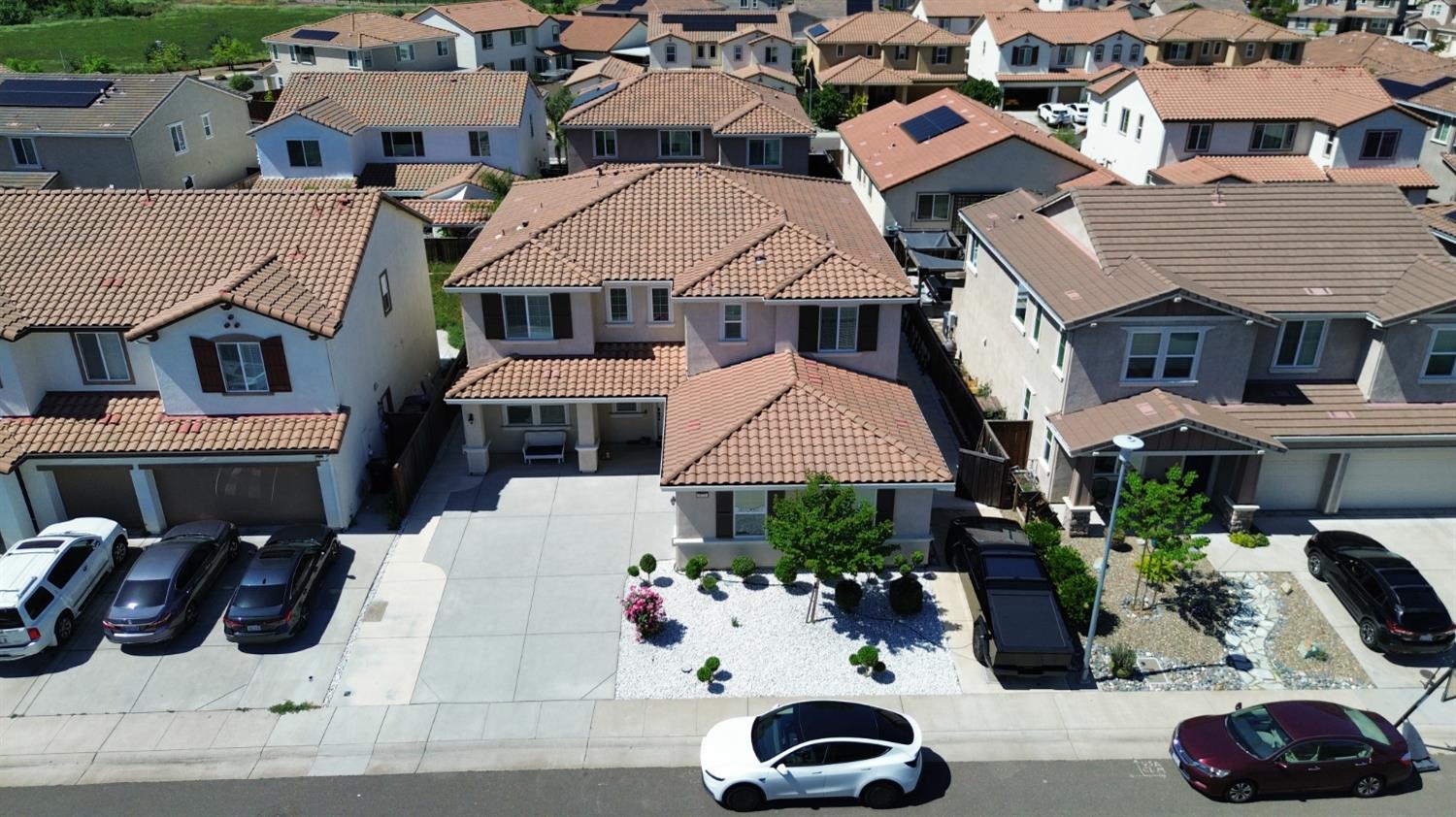 a view of multiple houses with cars
