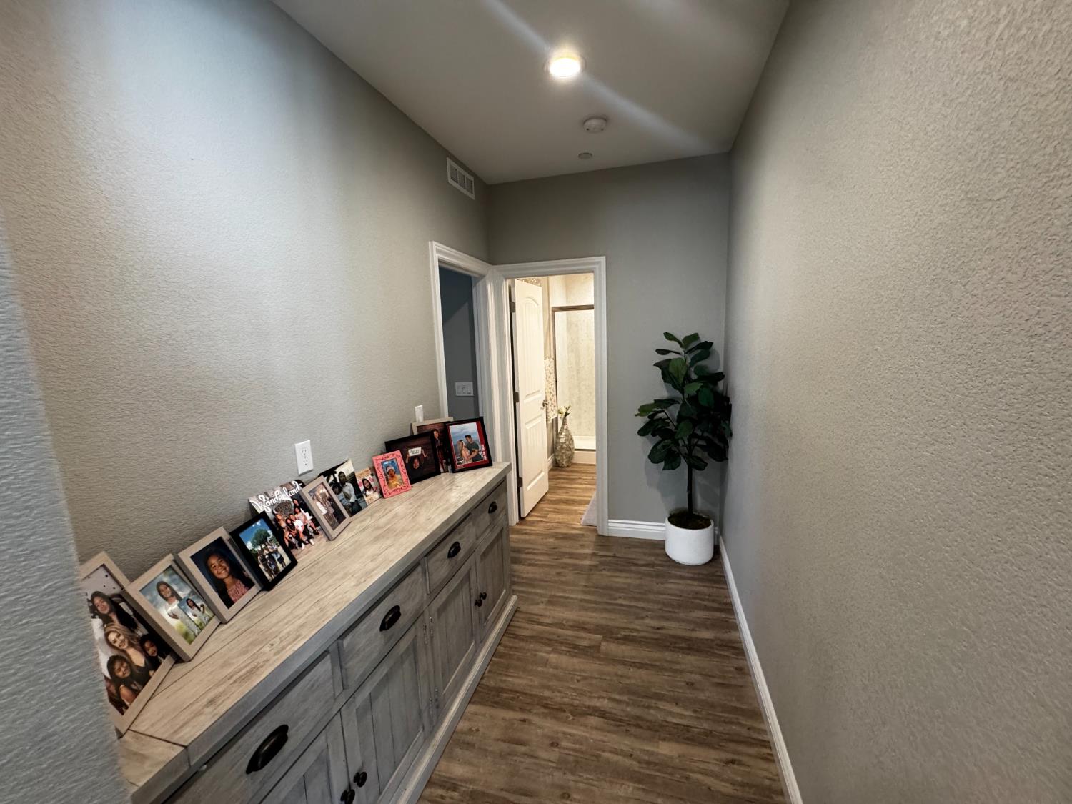 8026 Prairie Hawk Way Sacramento, CA 95829 - Photo 17 of 30 a hallway with furniture and wooden floor