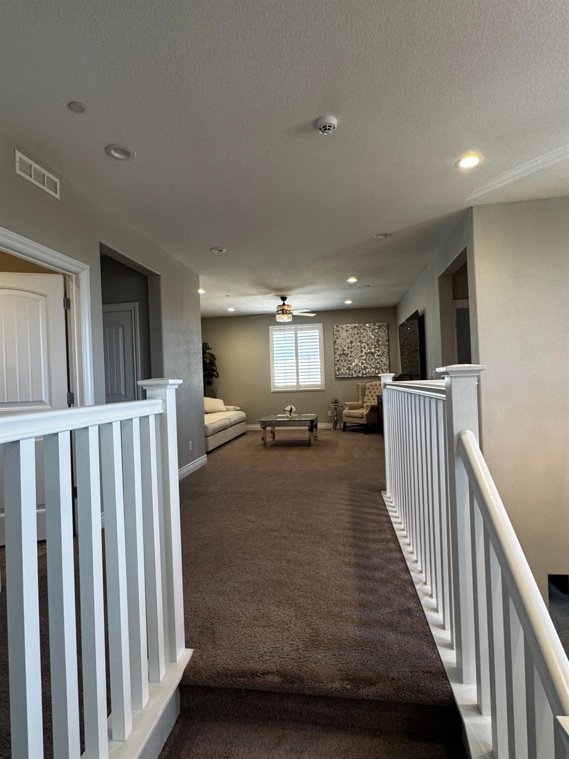 8026 Prairie Hawk Way Sacramento, CA 95829 - Photo 19 of 30 a view of a hallway with wooden floor and windows